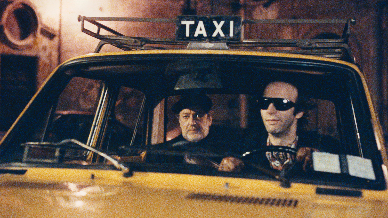 Scene from Night on Earth — yellow taxi cab at night
