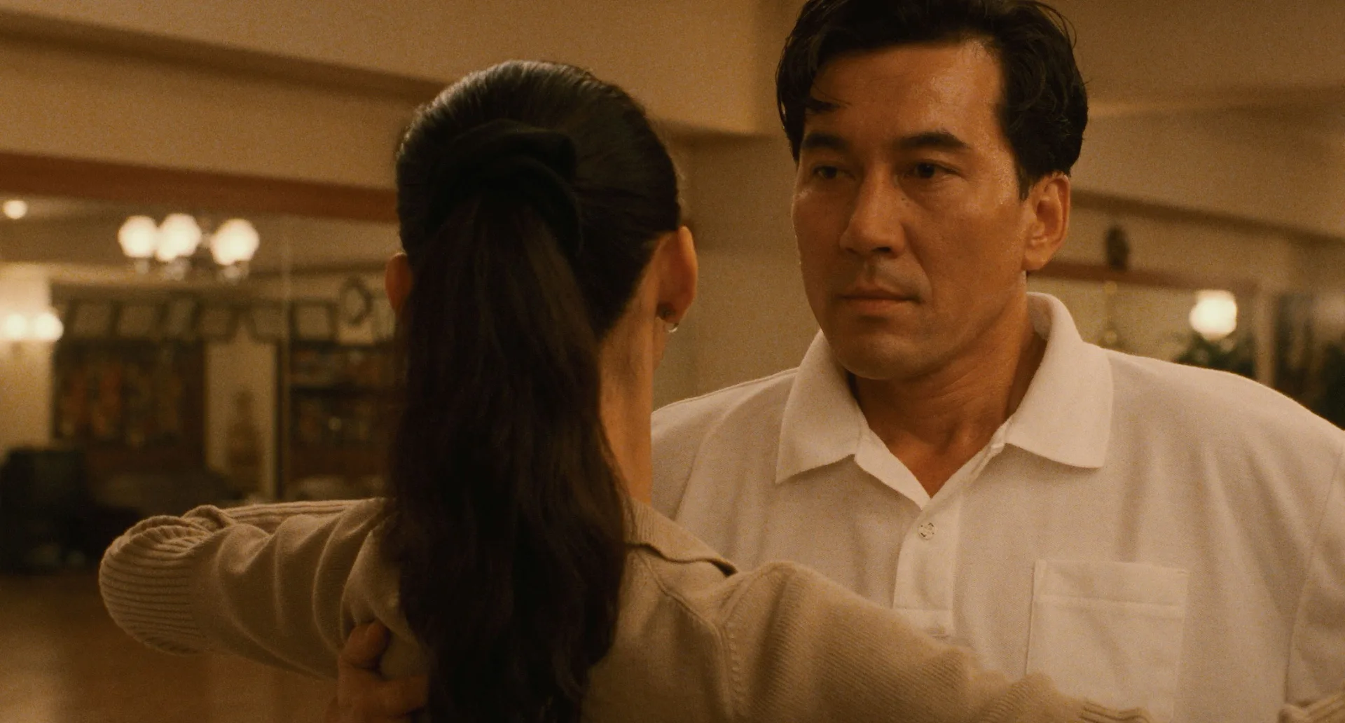 Koji Yakusho as Sugiyama faces his instructor Mai Kishikawa (Tamiyo Kusakari) during a lesson in Shall We Dance? (1996), directed by Masayuki Suō