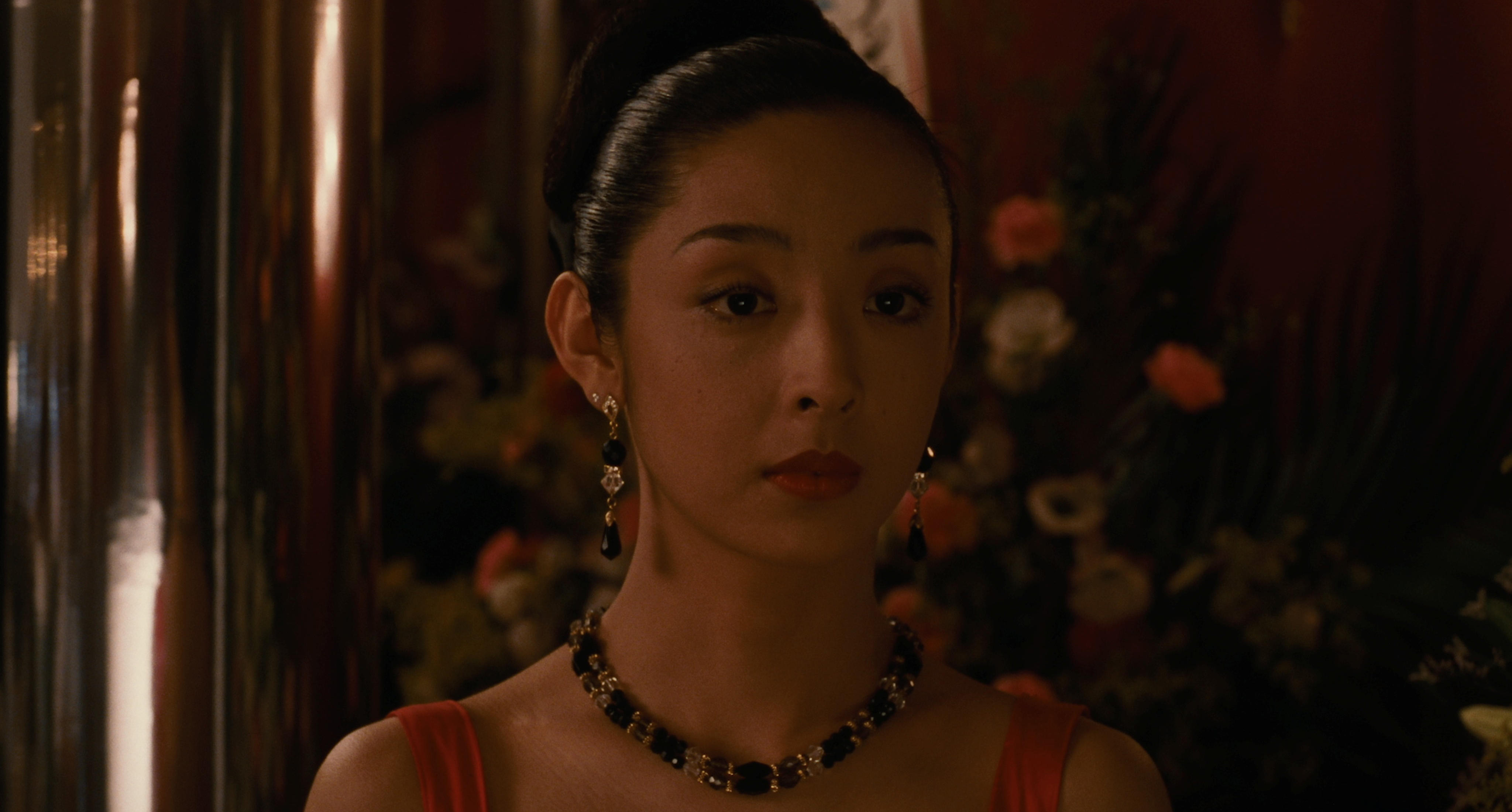 Tamiyo Kusakari as Mai Kishikawa, in a red dress and beaded necklace before a competition, in Shall We Dance? (1996)